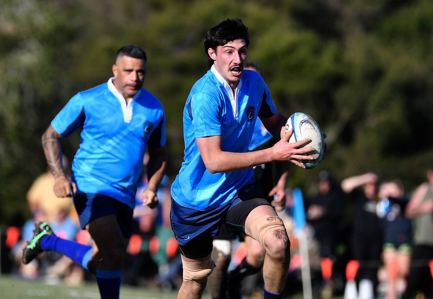Player running with the ball during the Capital Cup match at Russell Sports Club
