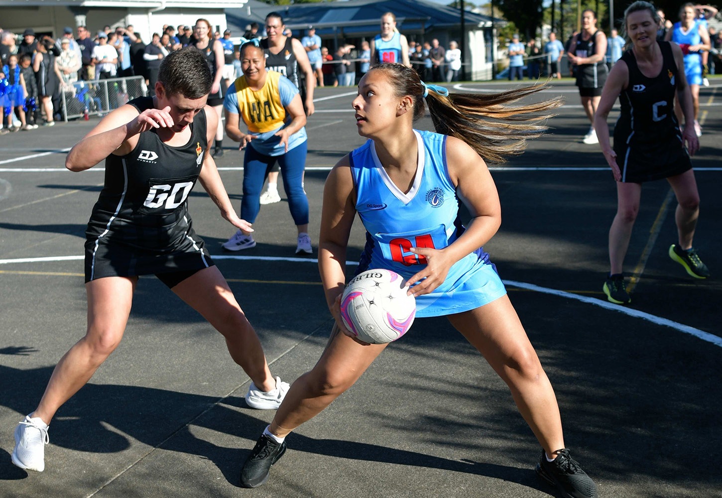 Parly Ferns netball player in action against Russell Invitational at Russell School
